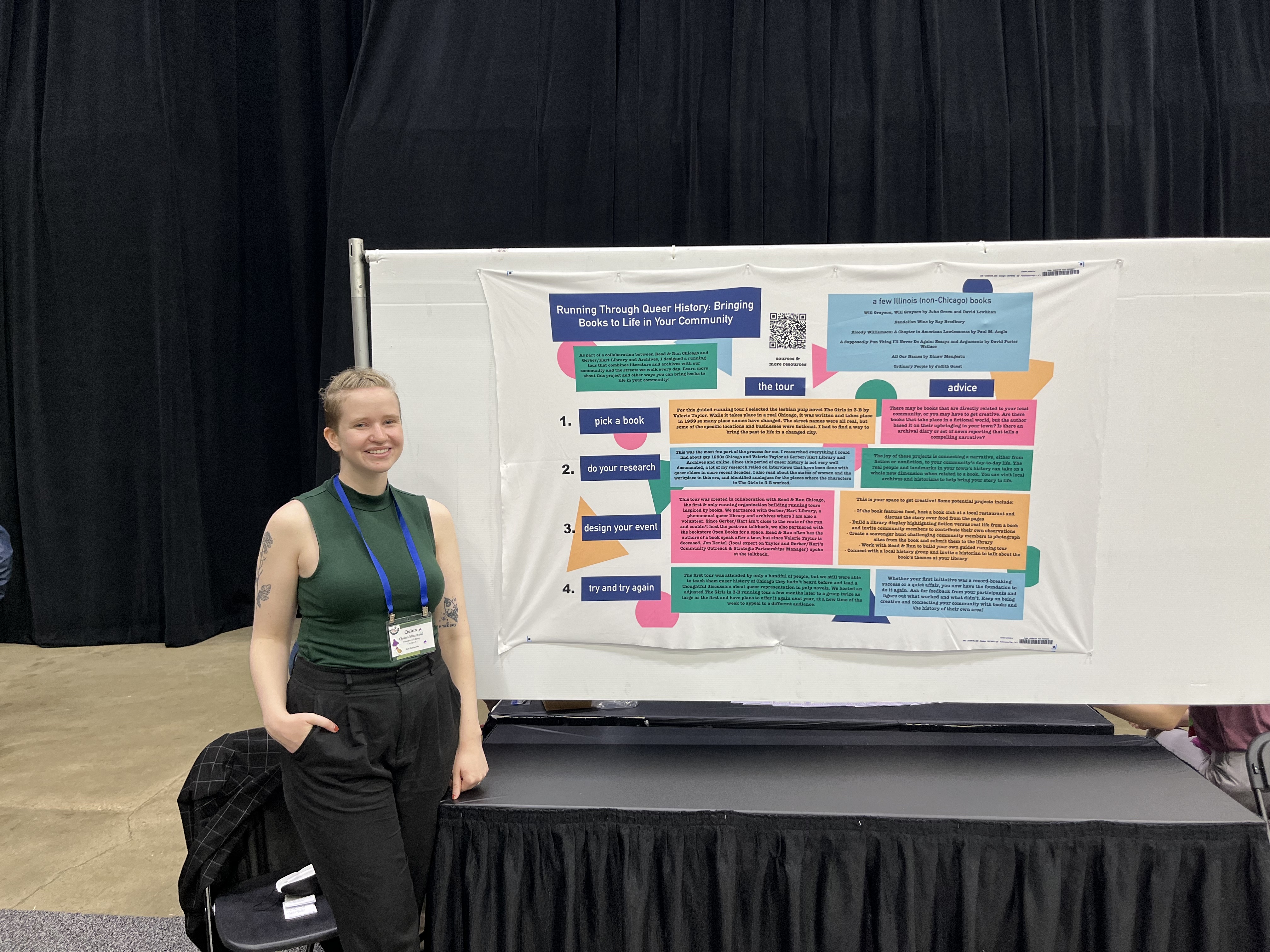 Quinn standing in front of Read and Run poster